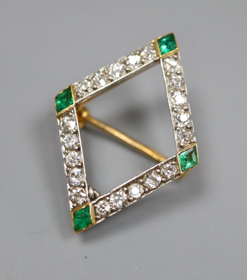 An early 20th century French yellow metal(18ct poincon mark), emerald and diamond set diamond shaped openwork brooch,